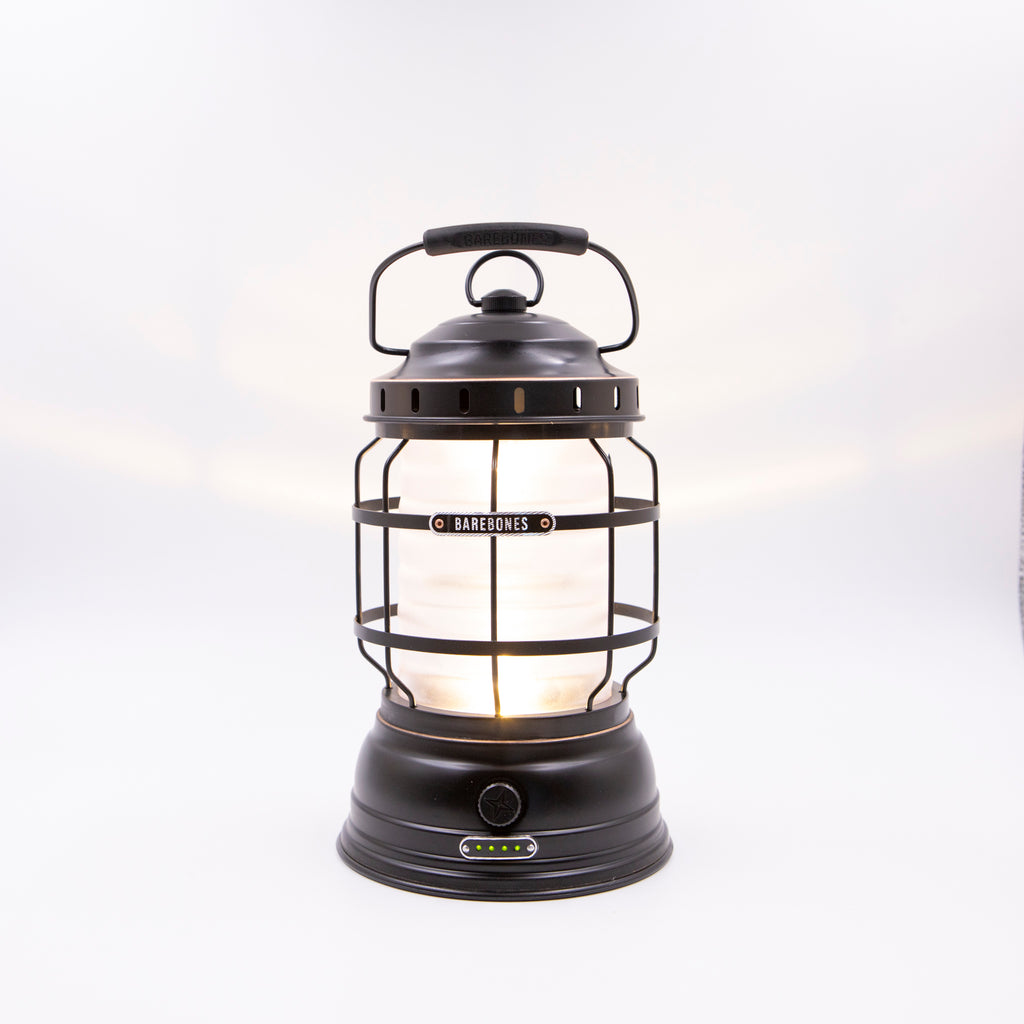 Image shows a traditional camping lantern with an oiled brass finish.