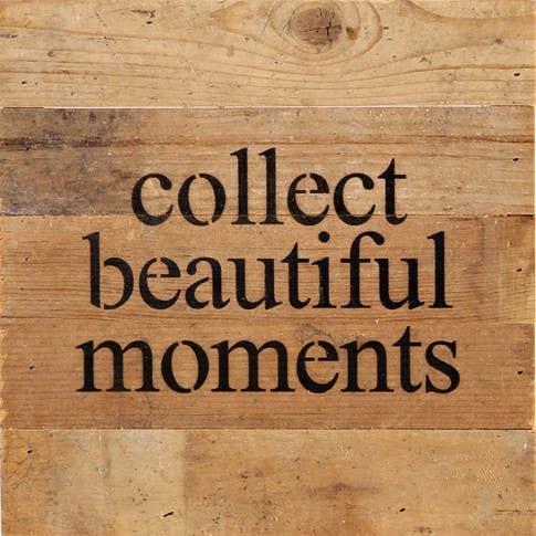 Image shows a natural wood sign. Text reads "collect beautiful moments"