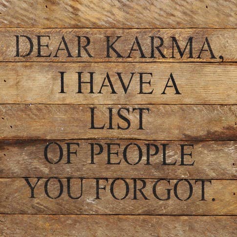 Image shows a natural wood sign. Text reads "Dear karma, I have a list of people you forgot."