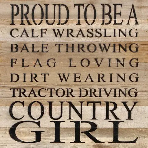 Image shows a natural wood sign. Text reads "Proud to be a calf wrassling, bale throwing, flag loving, dirt wearing, tractor driving country girl".