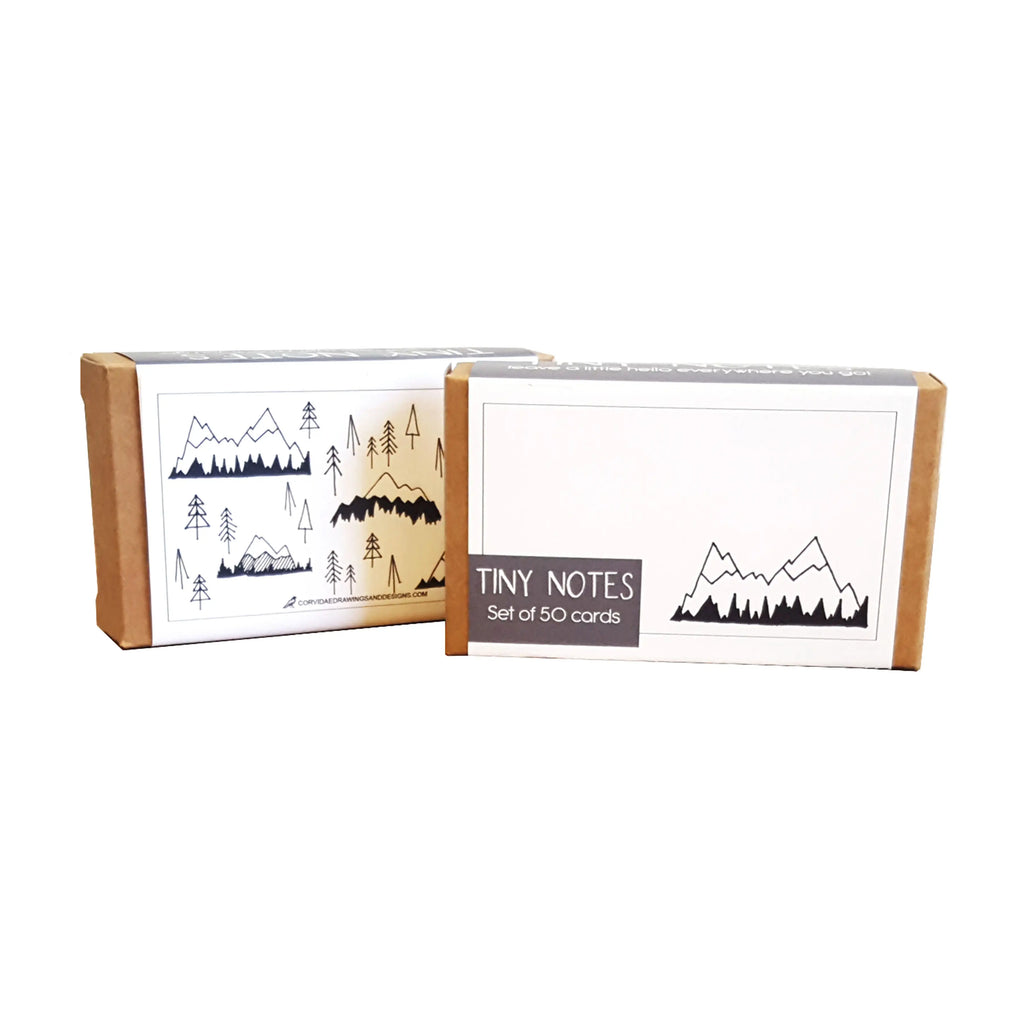 Picture shows the front and back of the "The Mountains are Calling" Tiny Notes on a white background. Front shows a single mountain and the back shows artfully scattered mountains and trees.