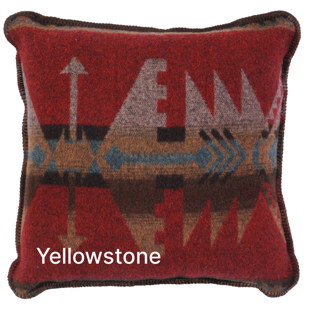 Image shows a mostly red pillow with an intricate geometric design with hints of black, blue, beige, and brown inside.